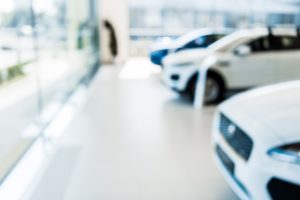 blurred car showroom with new and shiny cars