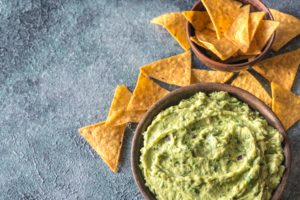 Guacamole in bowl with tortilla chips