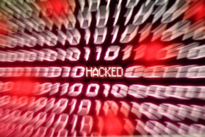 HACKED Computer binary number stream blurred. Concept for hacker cyber attack danger