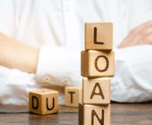 Wooden blocks with the word loan and businessman