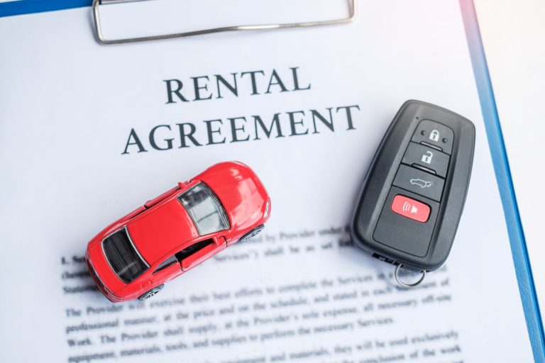 contract document with car and remote key. buy and sale, insurance, rental and contract agreement