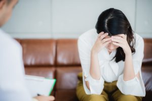 Mental Health concept, psychologist comforting his depressed patient