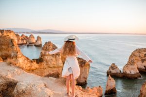 Woman traveling on the rocky coastline in Lagos, Portugal
