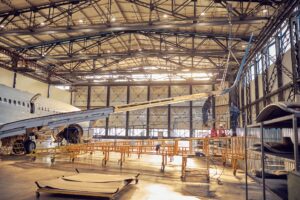 Wing and fuselage of the airplane in the aviation hangar