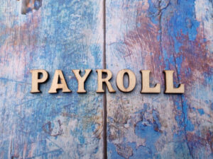 Wooden letters arranged with the word PAYROLL
