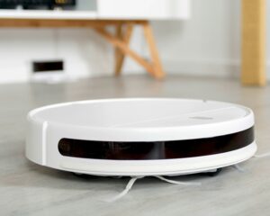 Close-up image of robot vacuum cleaner on living room floor.