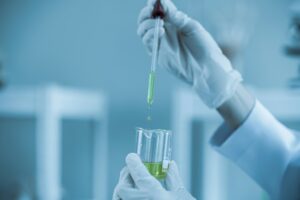 scientists conducting research investigations in a medical laboratory, a researcher in the foregroun