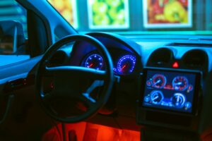 The interior of the modern car with a red backlight. evening night time