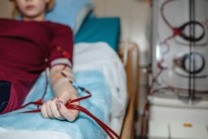 Young girl on hemodialysis in hospital, dialysis system equipment, kidney disease chronic patient