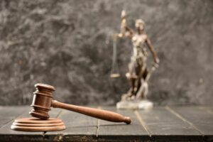 Close-up view of brown mallet of judge on wooden table, law concept